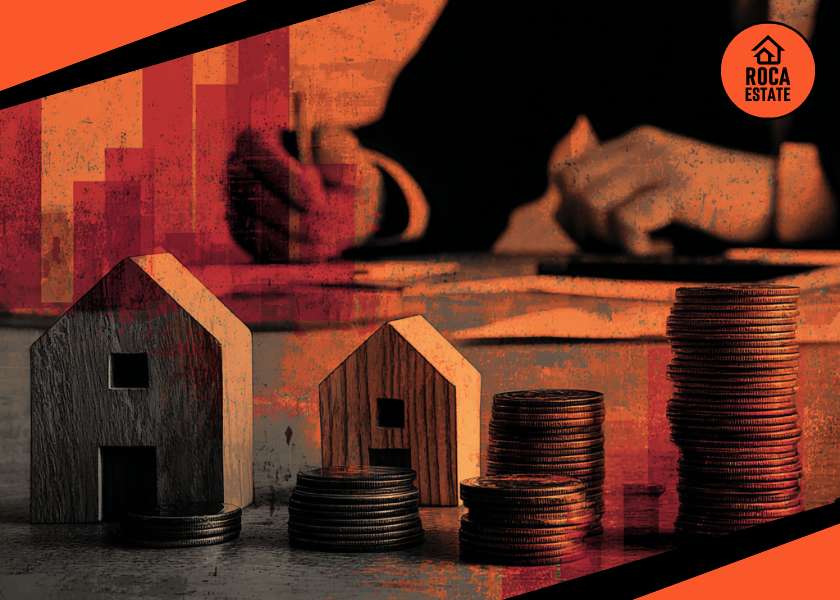Person analyzing housing investments with wooden house models and coins, representing trends in the Portuguese housing market.