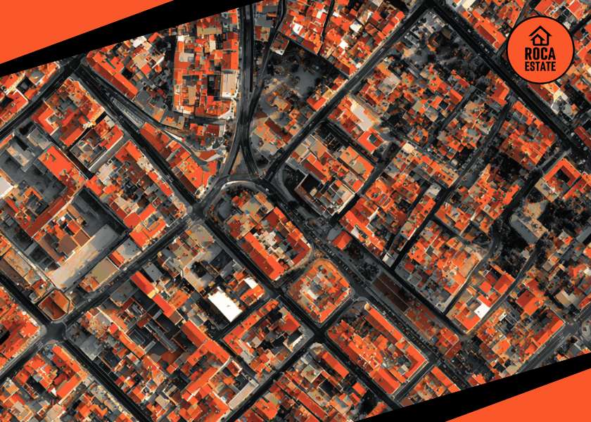 Aerial view of a dense urban Portuguese neighborhood illustrating Portugal mortgage rates trends and their relevance to real estate investment analysis.