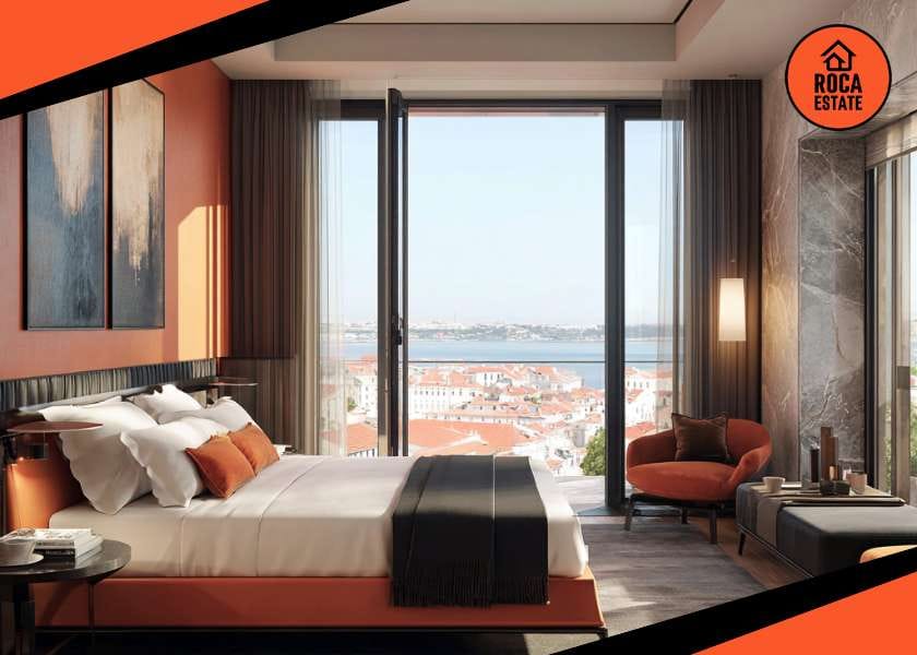 Luxury hotel room in Lisbon with river views, representing a prime Portugal hospitality real estate investment. Modern interior, oak floors, and large windows highlighting premium asset value.